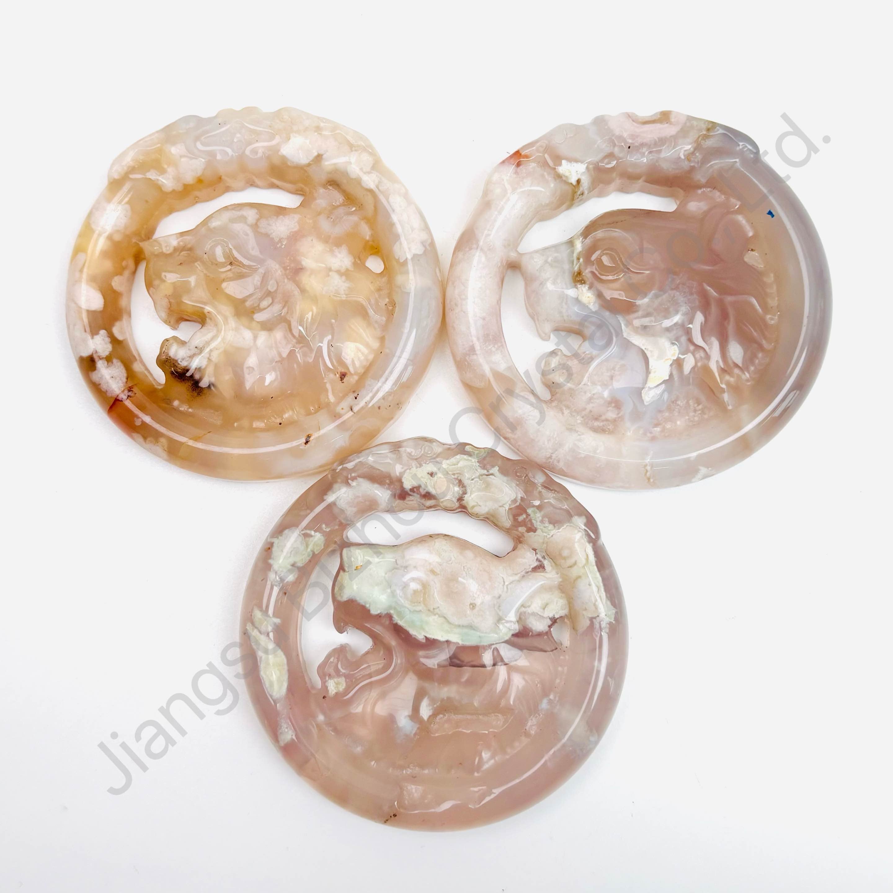 Purely hand-carved round agate pendant with alternating pink cherry blossom and agate patterns.